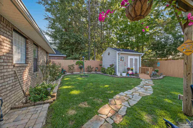 a view of a patio with couches table and chairs and potted plants