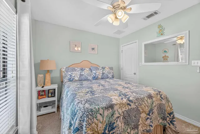 a large bed sitting in a bedroom next to a window