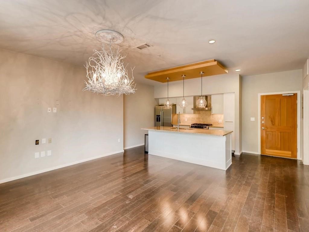 1600 Barton Springs Road, Unit 5208 Austin, TX 78704 - Photo 3 of 11 a large white kitchen with a refrigerator and a dishwasher