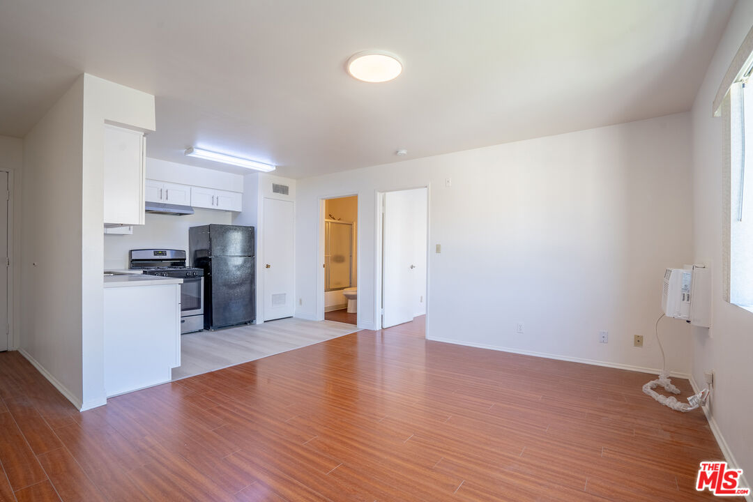 820 South St Andrews Place, Unit 304 Los Angeles, CA 90005 - Photo 2 of 16 a view of kitchen with refrigerator and wooden floor