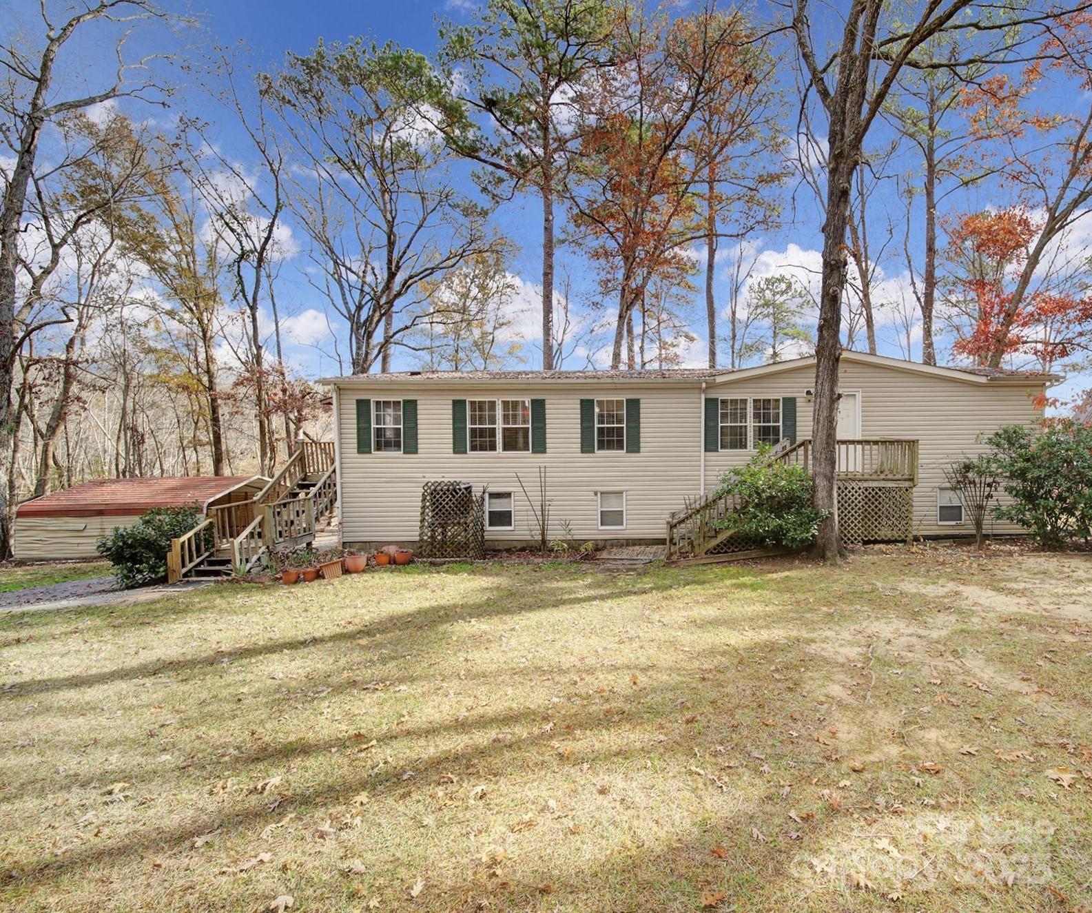 a view of a house with a patio and a yard