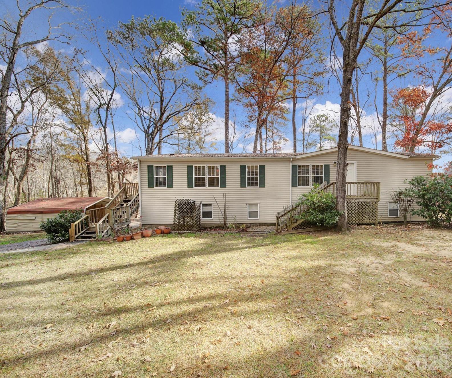 a view of a house with a patio and a yard