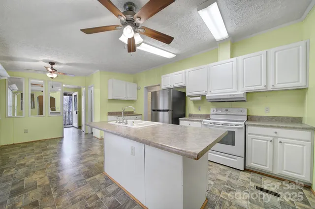 a kitchen with stainless steel appliances granite countertop a sink and cabinets
