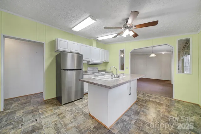 a kitchen with a refrigerator a sink and a refrigerator