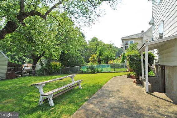 1253 Elm Road Baltimore, MD 21227 - Photo 21 of 29 a view of a park with a bench and trees
