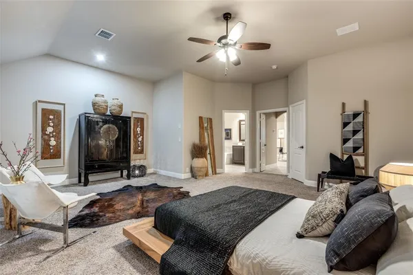 a bedroom with a bed and a chandelier