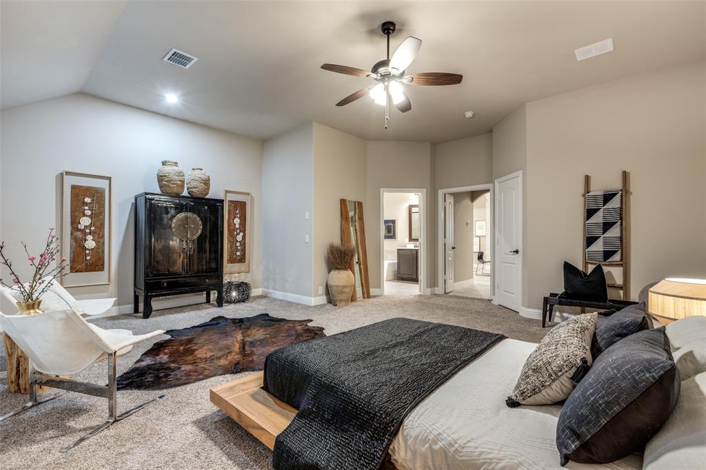 1605 George Lane Little Elm, TX 75068 - Photo 15 of 25 a bedroom with a bed and a chandelier