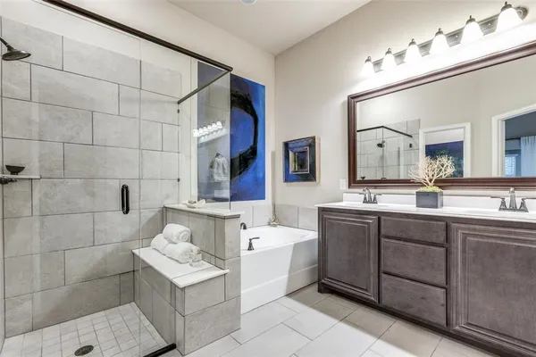 a bathroom with a sink mirror and a bathtub