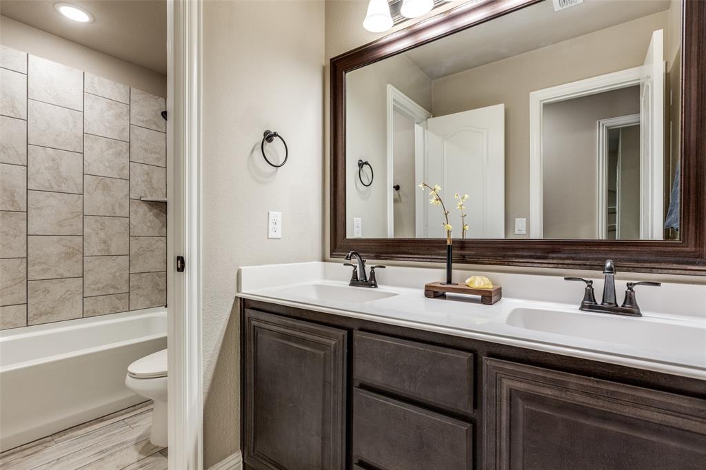 1605 George Lane Little Elm, TX 75068 - Photo 17 of 25 a bathroom with a sink and a mirror