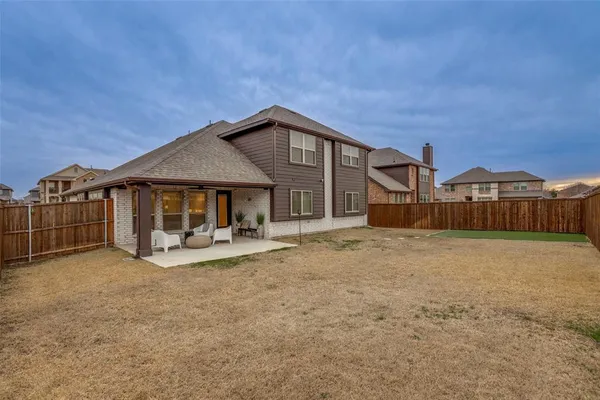 a view of a house with wooden fence