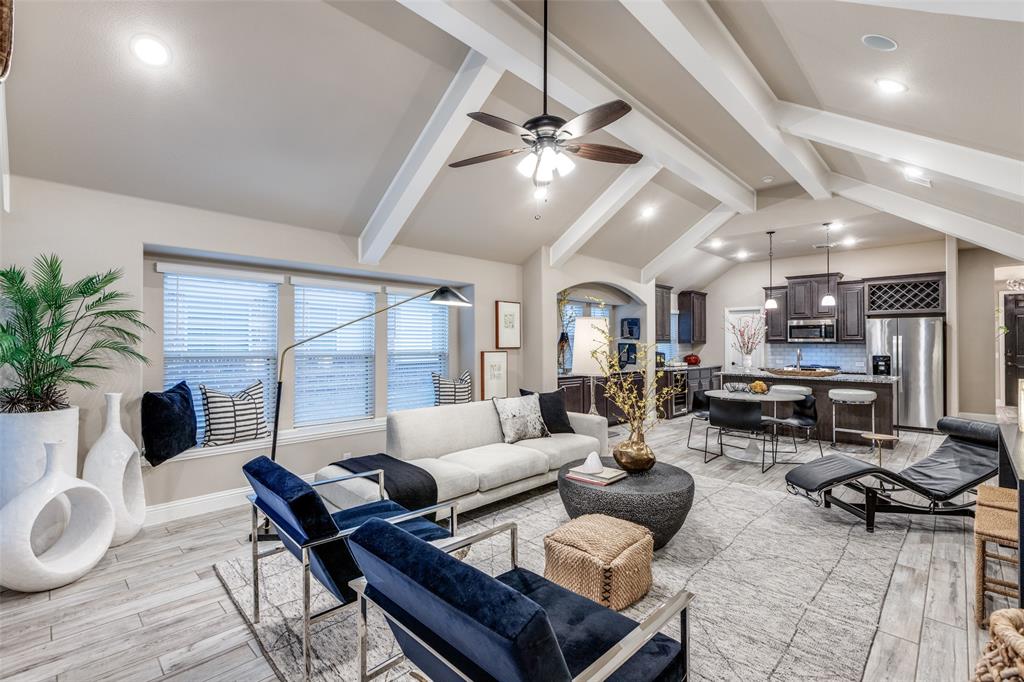 1605 George Lane Little Elm, TX 75068 - Photo 10 of 25 a living room with furniture a chandelier and a floor to ceiling window