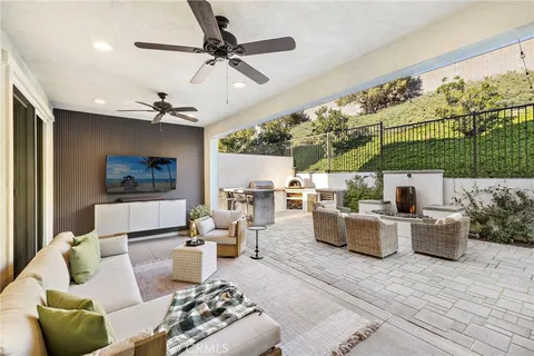 a living room with furniture and a ceiling fan