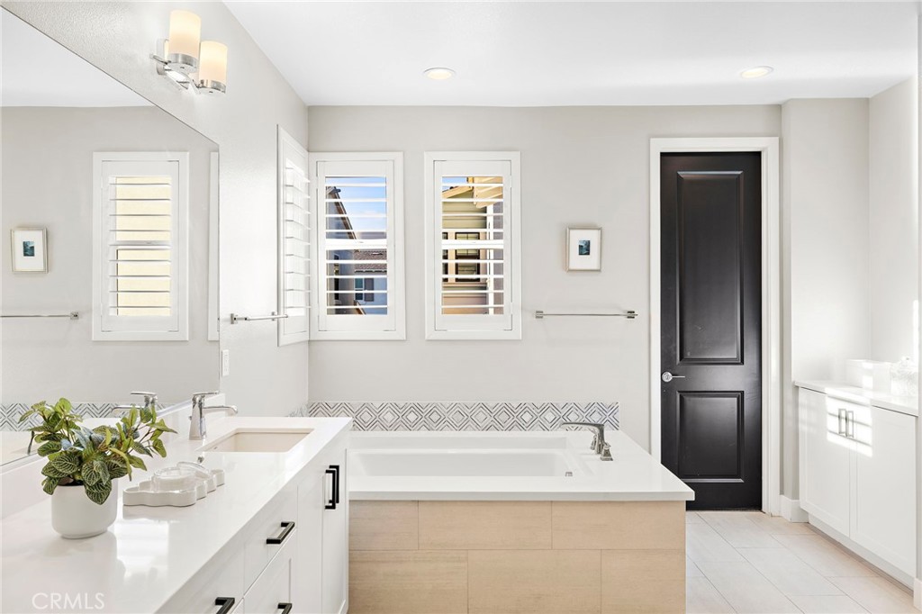 48 Jarano Street Rancho Mission Viejo, CA 92694 - Photo 23 of 75 a bathroom with a sink a faucet a potted plant and a shower