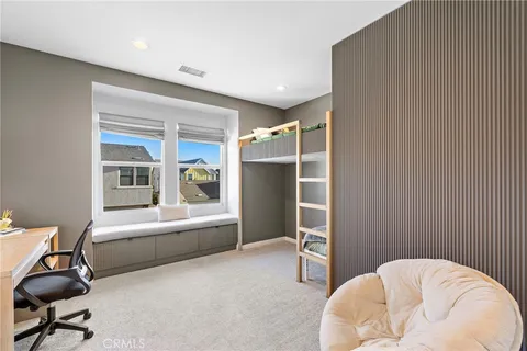 a view of walk in closet with clothes