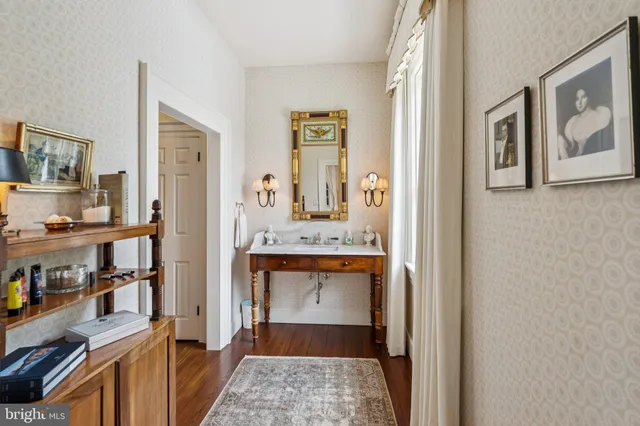a view of a tennis ground with large trees
