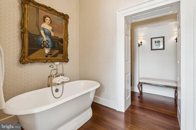 a front view of a house with a yard and a garden