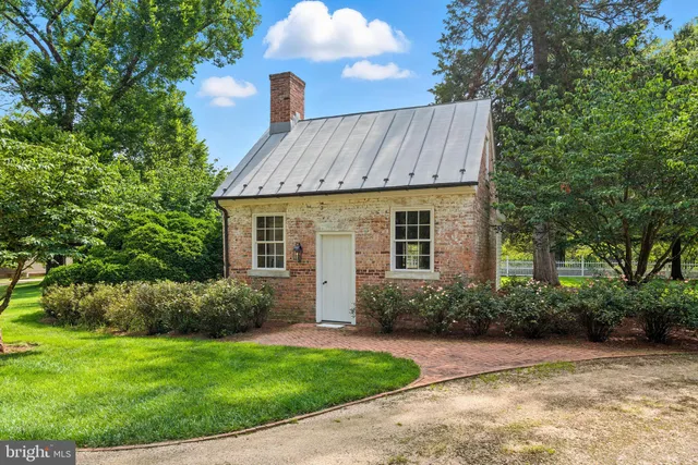 a front view of house with yard and trees