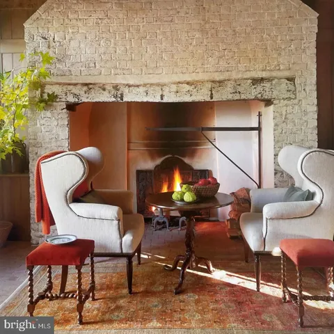 a view of a wooden chairs and table in a backyard