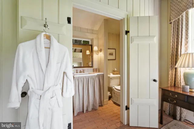 a front view of a house with a garden and trees