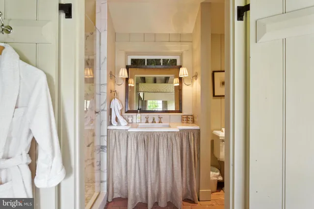 a front view of a house with a yard and potted plants