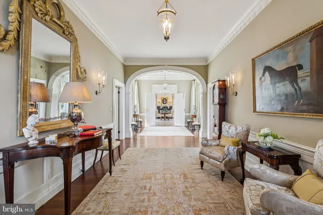 a dining room with furniture a chandelier and wooden floor
