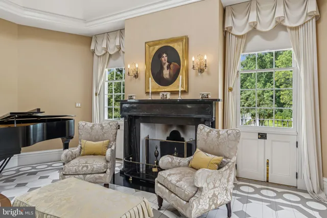a living room with furniture a window and a chandelier