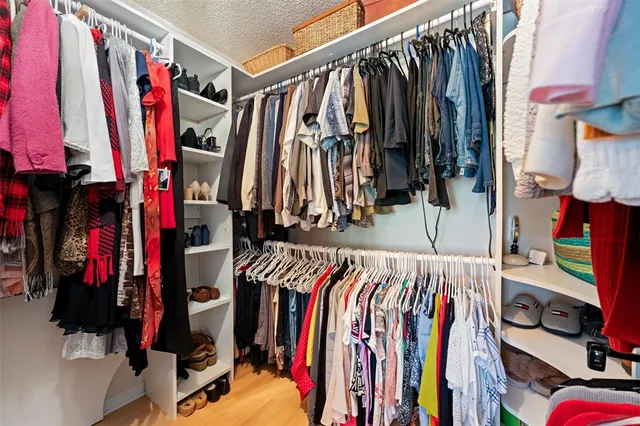 a bathroom with a granite countertop sink a mirror and a toilet