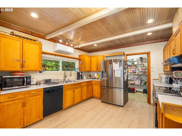 a kitchen with stainless steel appliances granite countertop a refrigerator and a stove
