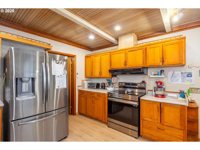 a open kitchen with stainless steel appliances kitchen island granite countertop a sink and cabinets