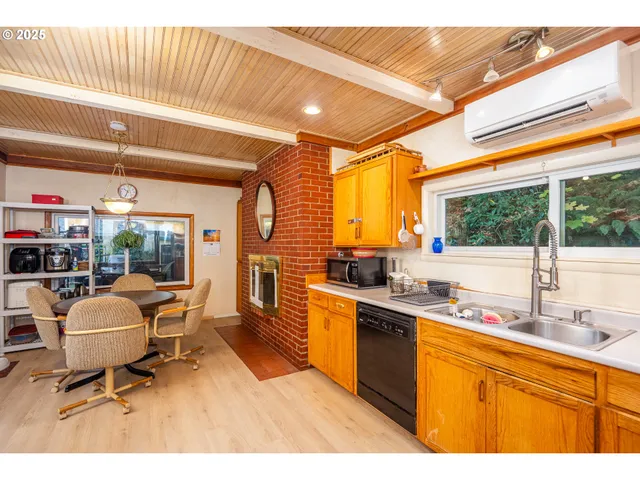 a dining room with a wooden table and chairs