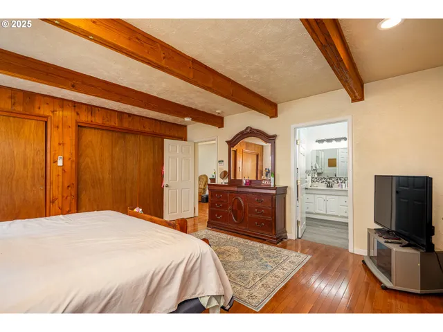 a bed room with a bed window and a chair