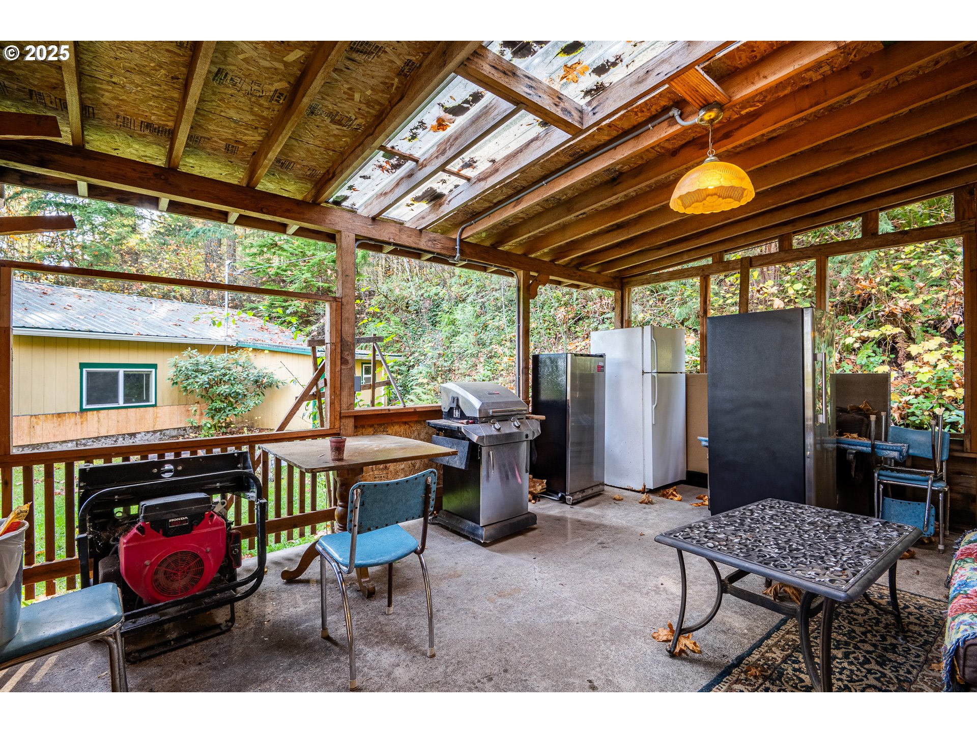 87250 Cedar Flat Road Springfield, OR 97478 - Photo 27 of 48 a view of a chairs and table in the patio next to a yard