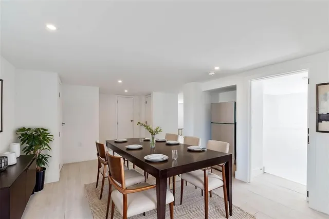 a view of a dining room with a table and chairs