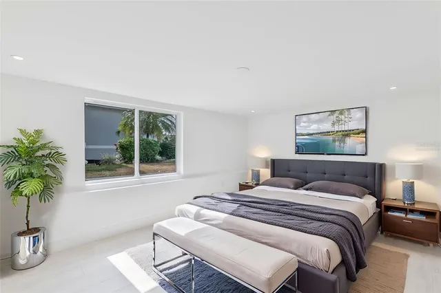 a bedroom with a bed and a potted plant