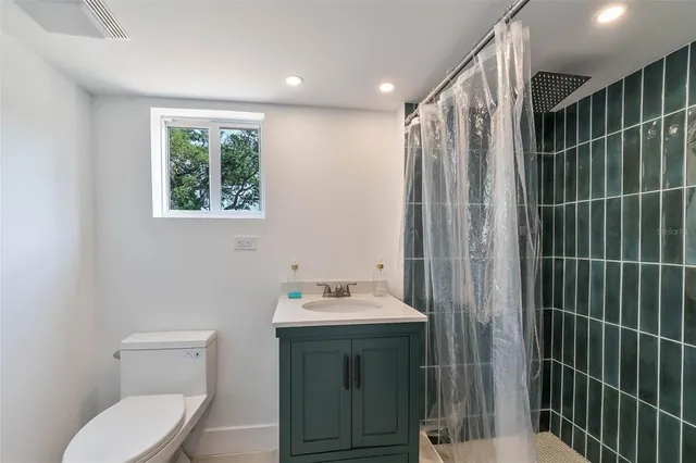 a bathroom with a sink toilet and shower