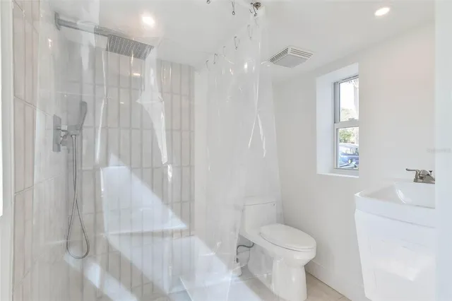 a bathroom with a sink toilet and shower