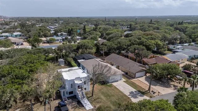 an aerial view of a house with a yard and lake view
