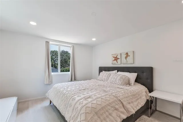 a bedroom with a large bed and a window