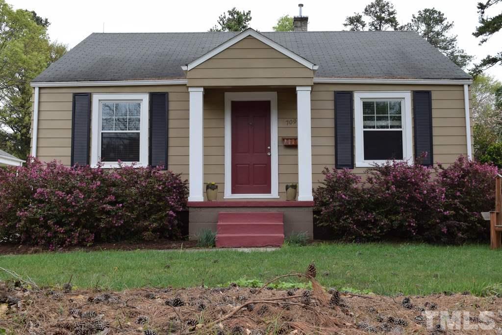 709 East Whitaker Mill Road Raleigh, NC 27608 - Photo 1 of 18 a front view of a house with garden