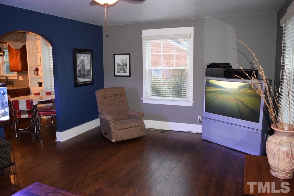 709 East Whitaker Mill Road Raleigh, NC 27608 - Photo 7 of 18 a living room with furniture and a flat screen tv