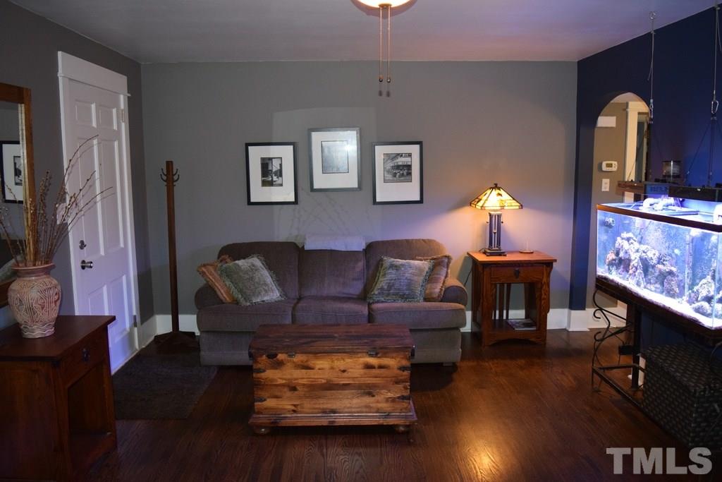 709 East Whitaker Mill Road Raleigh, NC 27608 - Photo 8 of 18 a living room with furniture and a fireplace