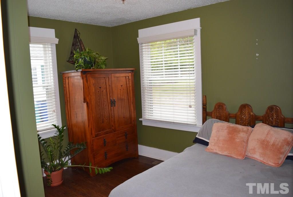 709 East Whitaker Mill Road Raleigh, NC 27608 - Photo 10 of 18 a bedroom with furniture and a window