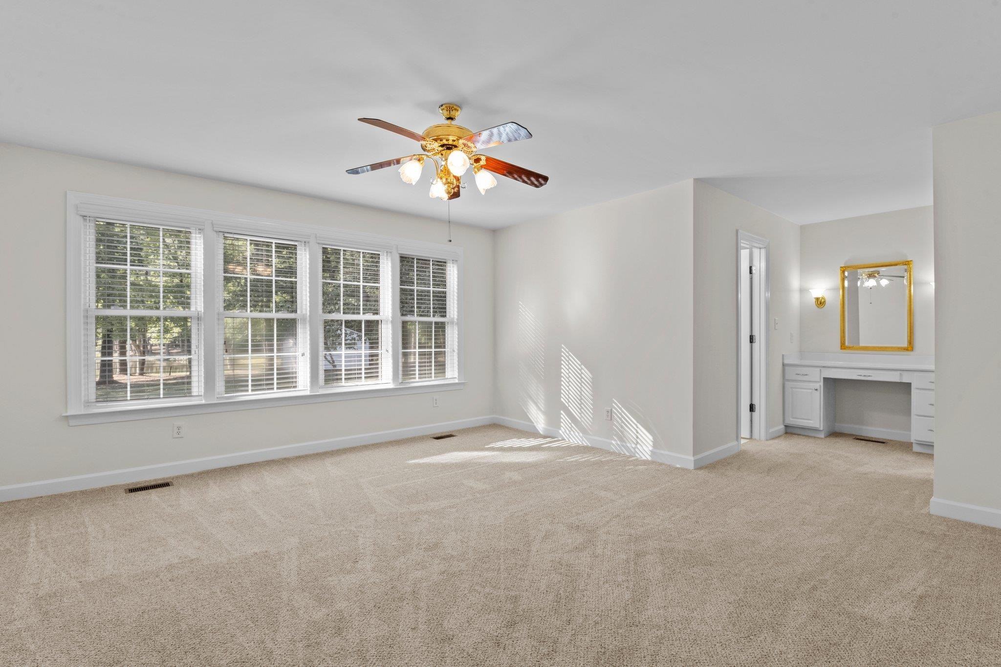 8025 Lockleair Road Zebulon, NC 27597 - Photo 23 of 30 Spacious Master bedroom can accommodate king sized furniture. Lots of natural light from wall of windows with views of back yard and neighboring pond. D Dressing area located between bath and walk-in-closet. Freshly painted Master Bedroom