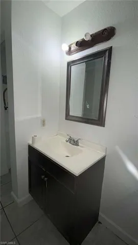 a bathroom with a sink vanity and mirror