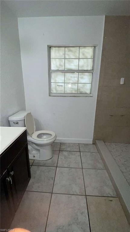 216 Maria Street Fort Myers, FL 33916 - Photo 12 of 19 a bathroom with a toilet a sink and a window