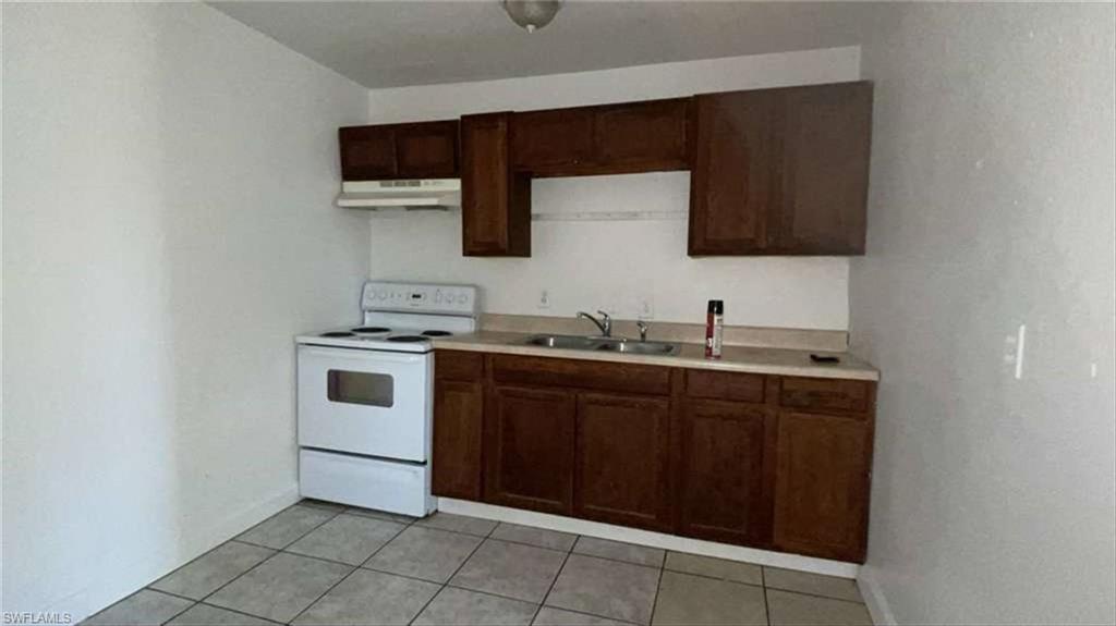 216 Maria Street Fort Myers, FL 33916 - Photo 14 of 19 a kitchen with a sink and a stove top oven