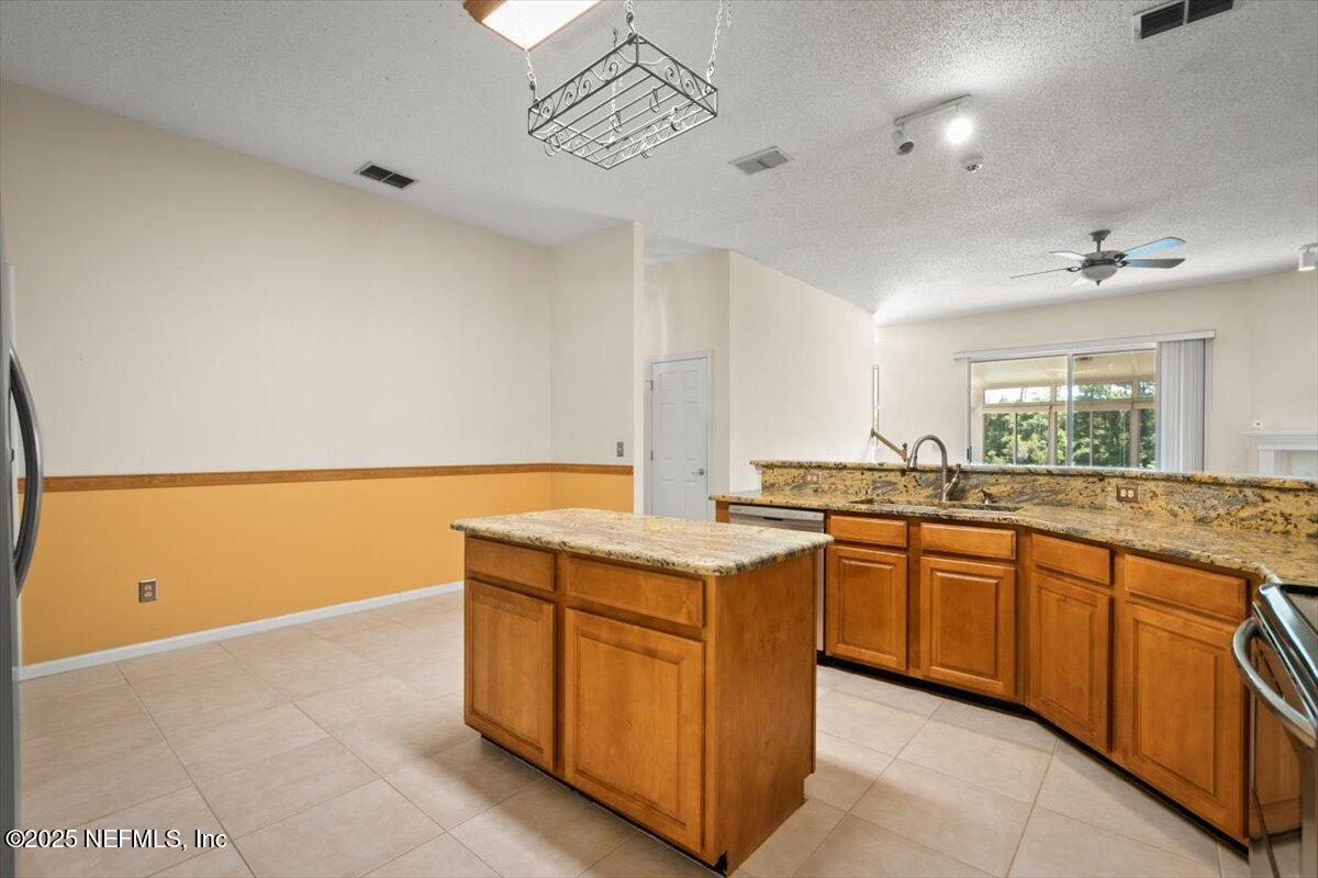 1385 Soaring Flight Way Jacksonville, FL 32225 - Photo 11 of 34 a kitchen with granite countertop a sink and a stove