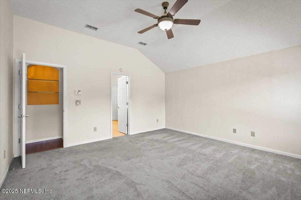 1385 Soaring Flight Way Jacksonville, FL 32225 - Photo 14 of 34 an empty room with a ceiling fan and a window