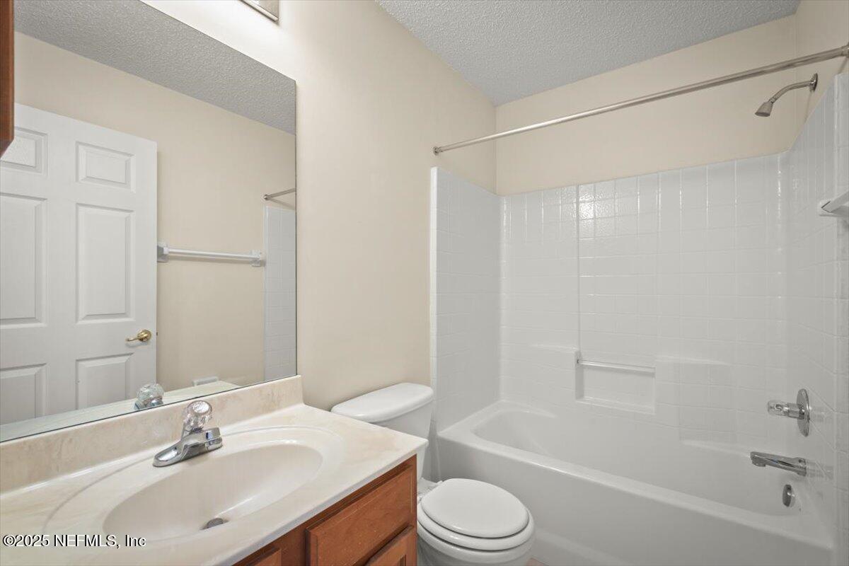 1385 Soaring Flight Way Jacksonville, FL 32225 - Photo 22 of 34 a bathroom with a bathtub shower sink vanity mirror and toilet