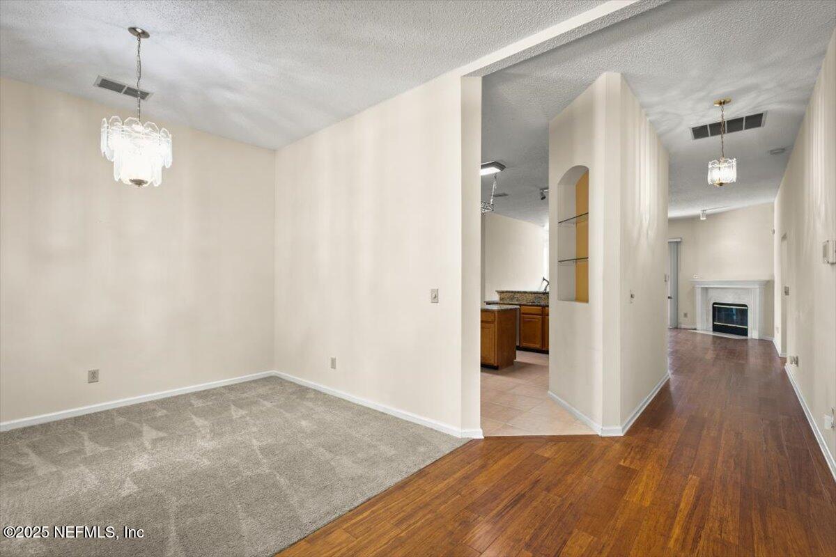 1385 Soaring Flight Way Jacksonville, FL 32225 - Photo 3 of 34 a view of a hallway with wooden floor and a bathroom